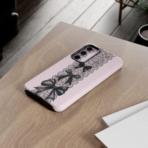 Coquette Phone Protection Case Pink Stripe Pattern Black Bow Design Lace Details Gothic Style Cover Premium Quality Construction Coquette Aesthetic Collection Dual Layer Protection iPhone Samsung Compatible Beautiful Fashion Accessory Elegant