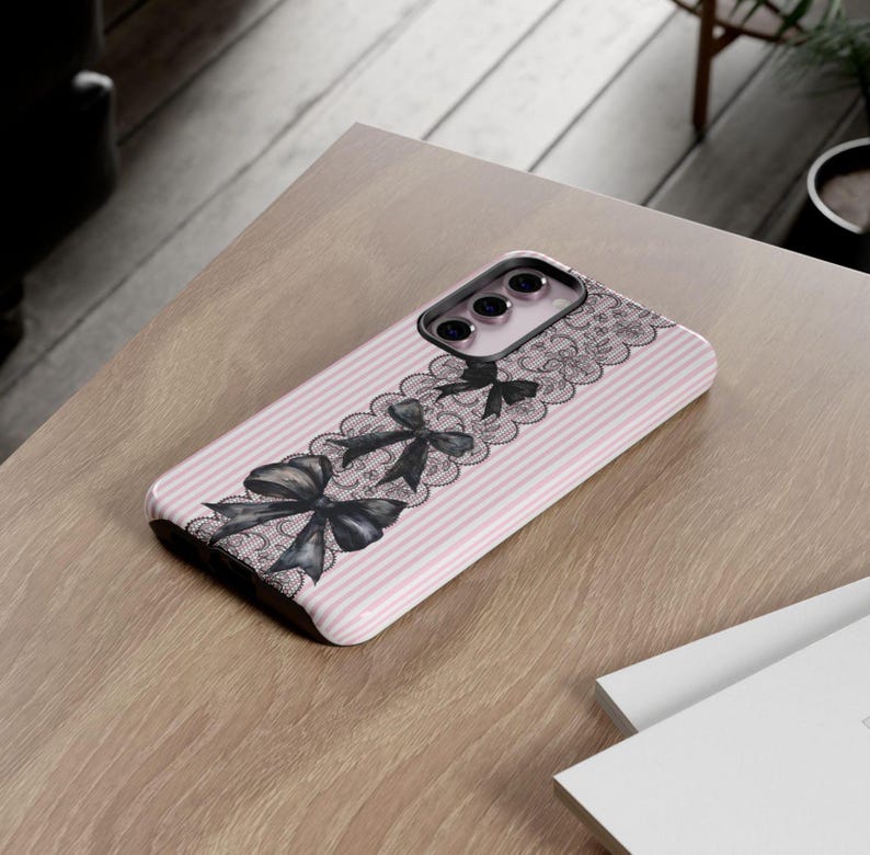 Coquette Phone Protection Case Pink Stripe Pattern Black Bow Design Lace Details Gothic Style Cover Premium Quality Construction Coquette Aesthetic Collection Dual Layer Protection iPhone Samsung Compatible Beautiful Fashion Accessory Elegant