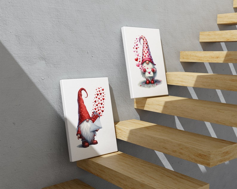 May include: Two white canvases with red and white gnomes holding letters with hearts floating around them. The canvases are on a wooden staircase.