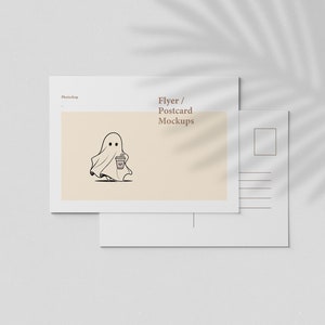 May include: Mockup of a blank white postcard with a light brown background and a ghost illustration holding a coffee cup. The text "Flyer / Postcard Mockups" is at the top of the postcard.