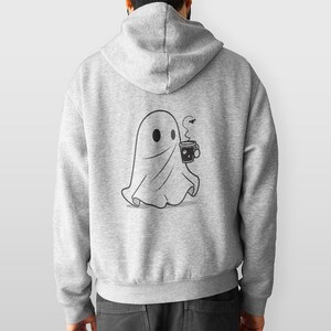 May include: A gray hoodie with a black and white illustration of a ghost holding a cup of coffee. The ghost is wearing a sheet and has a small smile on its face.