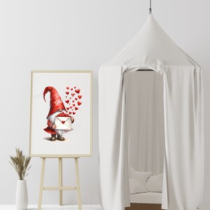 May include: A red and white gnome holding a white envelope with red hearts floating around him. The gnome is standing on a white background.