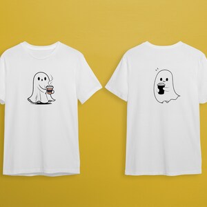 May include: Two white t-shirts with a cartoon ghost holding a cup of coffee. The ghost on the front of the shirt has a cup of coffee with steam coming from it. The ghost on the back of the shirt has a plain cup of coffee.