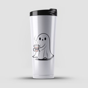 May include: White stainless steel travel mug with a black lid. The mug features a cartoon ghost holding a cup of coffee.