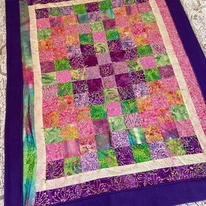 Purple batik quilt backed in Lux.