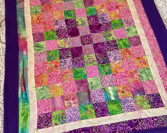 Purple batik quilt backed in Lux.
