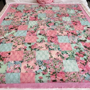 Floral patchwork Pink and mint Quilt, backed in pink and white Minky and hand tied to preserve softness! Free matching table runner!