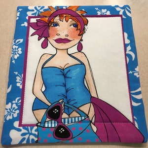 May include: A woman with red hair and a blue swimsuit is holding a blue and pink polka dot bag with sunglasses. She is standing in front of a white background with a blue and pink floral border.