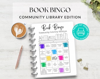 May include: A Book Bingo game with a coffee cup, pen, and binder clips. The game board has a library theme with various book-related prompts. The words "Book Bingo" and "Community Library Edition" are displayed at the top.