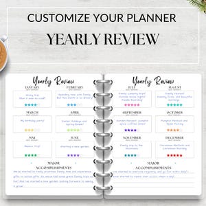 May include: A white planner with a black and grey cover. The planner has a yearly review section with a calendar layout for each month. The planner has a section for major accomplishments. The text "Customize Your Planner" and "Yearly Review" is at the top of the page.
