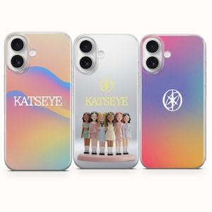 May include: Three phone cases with the word "KATSEYE" printed on them. The case on the left has a colorful gradient design. The middle case is clear with a doll display. The case on the right has a pink and purple gradient design.