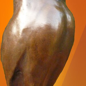 May include: A bronze owl sculpture with a smooth, reflective surface. The owl is depicted in a standing position, with detailed facial features and a rounded body. The background is a gradient of orange and yellow.