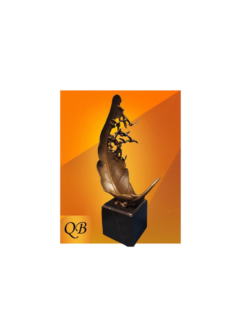 May include: Bronze feather sculpture with a black base. The feather design features intricate details and a stylized figure at the top, with several bird figures. The sculpture is set against an orange background. The letters "QB" are in the lower left corner.