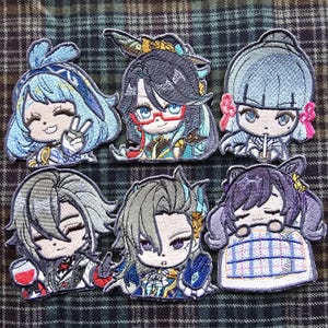 May include: Six embroidered patches featuring anime characters with colorful hair and clothing. The patches are made of fabric and have a soft, plush texture.