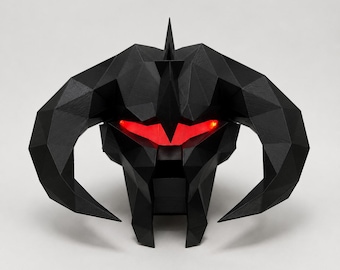 May include: A black, geometric sculpture of a horned creature's head with glowing red eyes. The sculpture has a pointed top and large, curved horns. The design is angular and modern, with a matte finish.