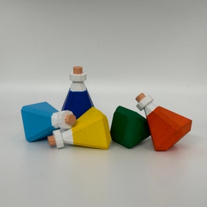May include: Five colorful geometric bottle stoppers in blue, yellow, green, and orange. The stoppers are made of a lightweight material and have a unique, modern design.