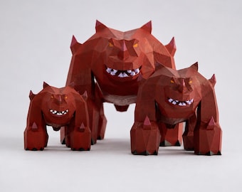 May include: Three red geometric monster sculptures with sharp edges and white teeth. The largest monster stands in the center, flanked by two smaller versions. The sculptures have a polygonal design and are set against a plain background.