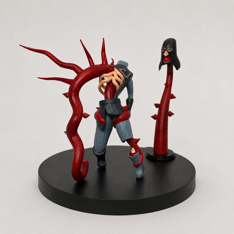 May include: A 3D-printed sculpture of a figure with a red vine-like structure and a detached head. The figure is wearing gray pants and a dark jacket. The sculpture is on a black circular base.