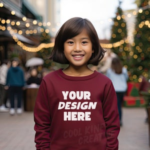 Gildan 18000B / G180B Sweatshirt Style Kids MAROON Crewneck Sweatshirt Mockup with Youth Asian Girl, Female Child Winter Christmas Diverse