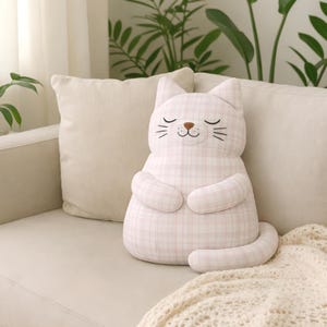 plush cat nursery decor, soft stuffed toy on sofa, cozy baby room
