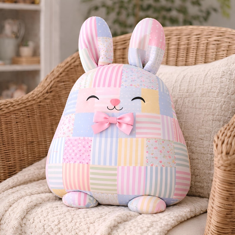Pastel patchwork bunny pillow with bow detail.
Soft pastel patchwork bunny pillow in pink and blue tones for beginner sewing project.