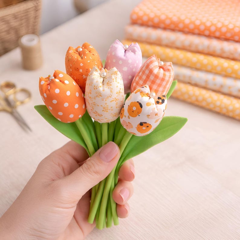 hand holding colorful fabric tulips made with DIY sewing pattern