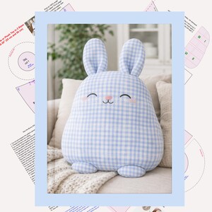 Front view of a blue gingham bunny pillow showing smooth rounded shape and upright ears and pages with pattern.