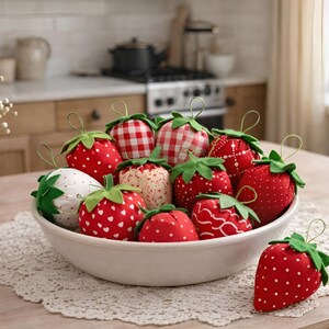 Bowl filled with red fabric strawberries with lace bows styled on lace doily in cozy home interior