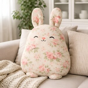 Floral bunny pillow , cottage style decor on a sofa.