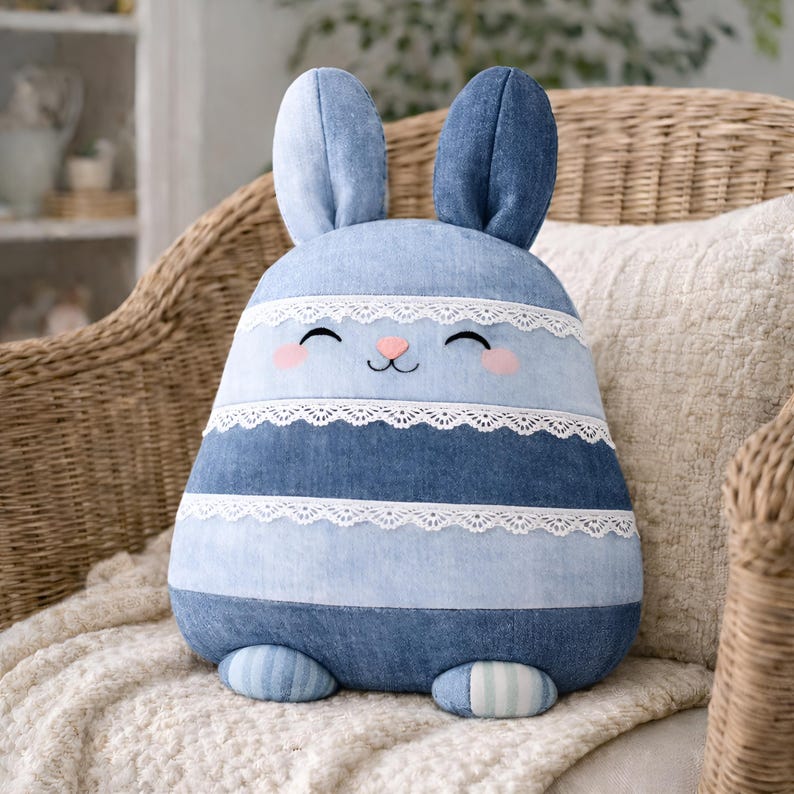 Blue denim striped bunny pillow with lace trim in cottage interior.