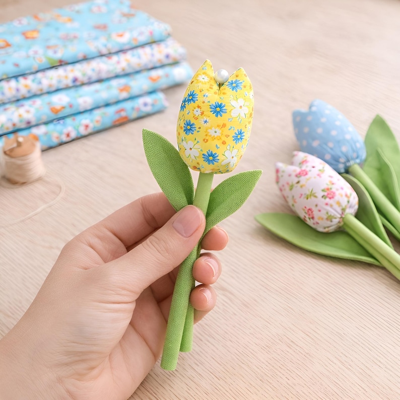 holding handmade fabric tulip flower in hand showing size DIY sewing pattern