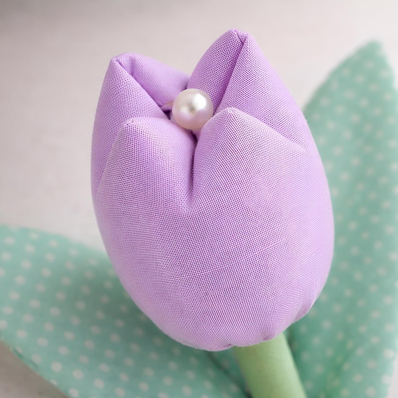 close up of handmade fabric tulip flower with bead center sewing pattern detail