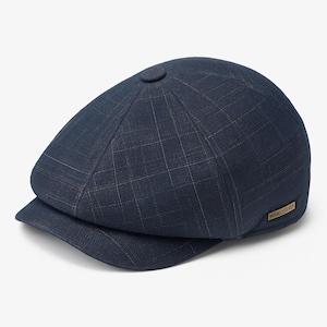 May include: A navy blue newsboy cap with a plaid pattern. The cap has a small, round button on top and a short, curved brim. A small, rectangular tag is on the side of the cap.