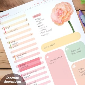 May include: A pink and green daily planner with a watercolor flower illustration. The planner has a list of tasks for each day of the week, including "Yoga", "Pack lunch", "Prep budget slides", "Lunch with Maria", "Budget meeting", and "Run accounting report".