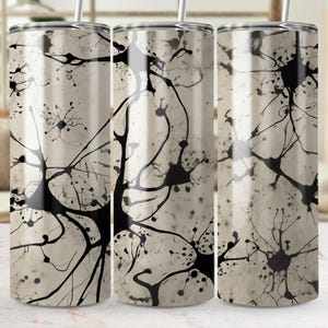 Pode incluir: Três copos de aço inoxidável com um design abstrato em preto e branco. O design apresenta um padrão de linhas e pontos interconectados, que se assemelha a uma rede de neurones.