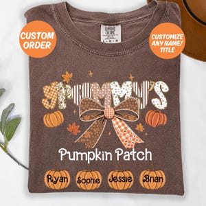Könnte beinhalten: Ein braunes T-Shirt mit dem Wort "Grammy's" in einer dekorativen Schriftart, einer großen Schleife und den Worten "Pumpkin Patch". Die Namen "Ryan", "Sophie", "Jessie" und "Brian" stehen unter Kürbissen. Das Shirt hat den Text "Custom Order" und "Customize Any Name/Title".