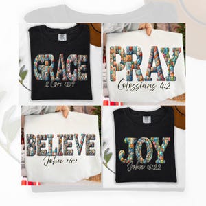 May include: Four t-shirts with inspirational words. The word "GRACE" is on a black tee, "PRAY" on a white tee, "BELIEVE" on a white tee, and "JOY" on a black tee. Each word is in a colorful mosaic design with a Bible verse.