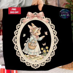 May include: A black tote bag with a watercolour illustration of an Easter bunny in a bonnet and dress, holding a basket of eggs. The image is framed by a decorative oval with a pink bow. Text "PNG 300 DPI" is in the upper left corner.