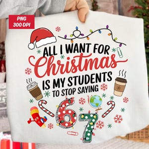 May include: White t-shirt featuring a Christmas design with a Santa hat, fairy lights, coffee cups, and candy canes. The text reads "ALL I WANT FOR CHRISTMAS IS MY STUDENTS TO STOP SAYING".