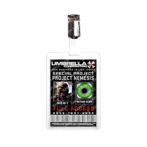 May include: A white plastic ID card with the text "UMBRELLA CORPORATION" and "SPECIAL PROJECT PROJECT NEMESIS". The card features a picture of a zombie-like creature and a green eye. The card also has the text "NEM 1 RETINA SCAN FULL ACCESS 9648-7997-0905".