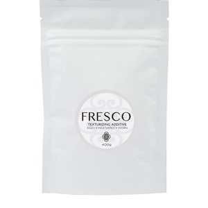 May include: White resealable pouch with a round label that says "FRESCO TEXTURIZING ADDITIVE AGED WEATHERED WORN 400g".