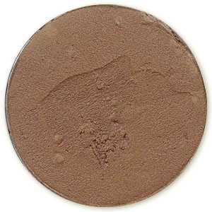 May include: A round, flat, brown-colored makeup compact. The compact has a smooth, matte finish.