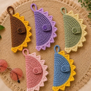 May include: Five semi-circular crochet pouches with hanging loops and button closures. Each pouch features a solid-colored body with a contrasting scalloped edge in yellow, light purple, light green, light pink, or blue, arranged in a circular pattern.