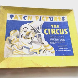 May include: A vintage "Patch Pictures The Circus" puzzle box. The box has a clown illustration with blue and yellow text. The box is yellow with a yellow border. The text on the box says "Entertaining, Educational".