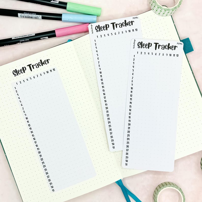 May include: Two white printable sleep trackers with black text. The trackers are labeled "Sleep Tracker" and have numbers 1 through 31 listed down the side and numbers 1 through 12 listed across the top.