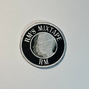 May include: A black and white embroidered patch with the text "RM'S MIXTAPE" and "RM" in a circle.