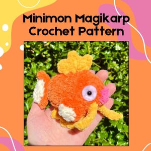 May include: An orange and yellow crochet Magikarp, a character from the Pokémon series, with white and pink accents. The crochet figure is held in a hand. Text at the top reads "Minimon Magikarp Crochet Pattern".