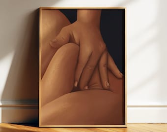 May include: A framed art print featuring a close-up of a hand resting on a thigh. The artwork has a warm color palette with shades of brown and tan. The frame is a light wood color, and the background is dark.