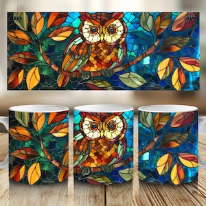 May include: Three white ceramic mugs with a stained glass owl design. The owl is surrounded by colorful leaves and a blue background. The mugs are perfect for coffee, tea, or hot chocolate.