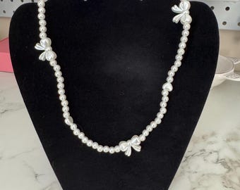 bow and pearl necklace